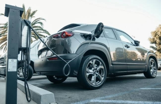 Electric vehicle charging station used after EV charger installation Perth in outdoor car park.